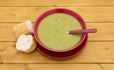 Image showing Full bowl of soup with slices of baguette