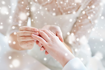 Image showing close up of lesbian couple hands with wedding ring