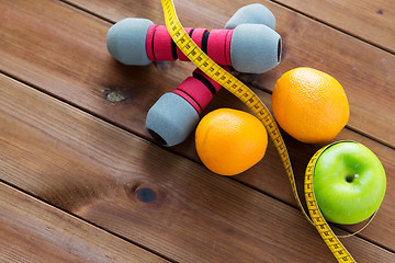 Image showing close up of dumbbell, fruits and measuring tape