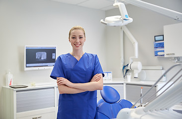 Image showing happy young female dentist at dental clinic office