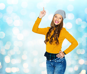 Image showing happy young woman or teen girl pointing finger up