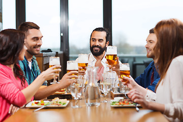 Image showing friends dining and drinking beer at restaurant
