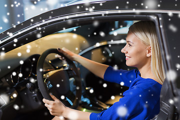 Image showing happy woman inside car in auto show or salon