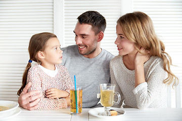 Image showing happy family having dinner at restaurant or cafe