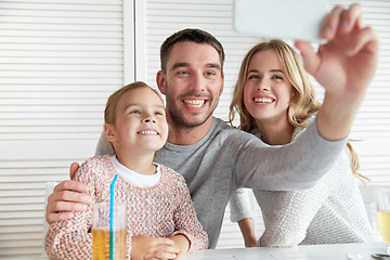 Image showing happy family taking selfie at restaurant