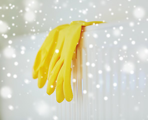 Image showing close up of rubber gloves hanging on heater