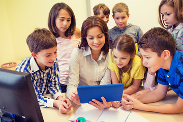 Image showing group of kids with teacher and tablet pc at school