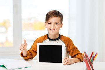 Image showing happy boy with tablet pc showing thumbs up at home