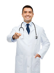 Image showing smiling male doctor in white coat pointing at you