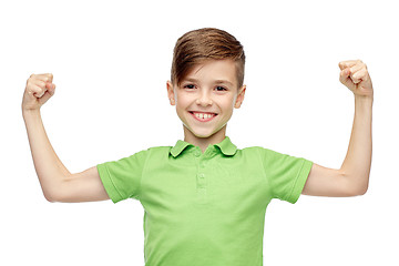 Image showing happy boy in polo t-shirt showing strong fists