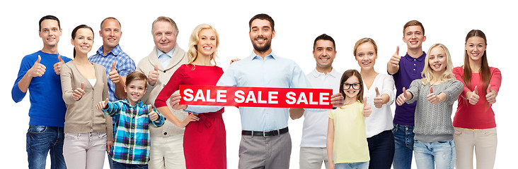 Image showing happy people with red sale sign showing thumbs up