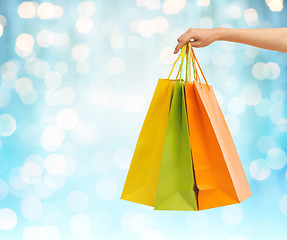 Image showing close up of hand holding shopping bags