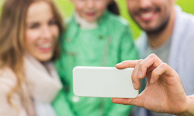 Image showing close up of family taking selfie by smartphone