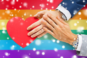 Image showing close up of male gay couple hands with red heart