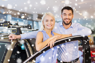 Image showing happy couple with car in auto show or salon