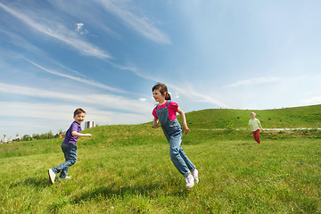 Image showing group of happy kids running outdoors