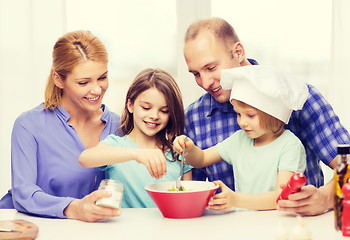 Image showing happy family with two kids eating at home