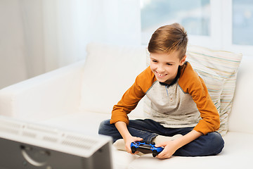 Image showing happy boy with joystick playing video game at home