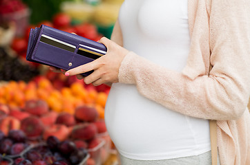 Image showing pregnant woman with wallet buying food at market