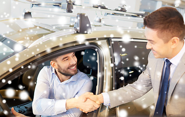 Image showing happy man with car dealer in auto show or salon