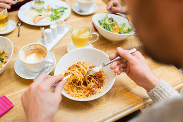 Image showing close up man eating pasta for dinner at restaurant