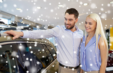 Image showing happy couple buying car in auto show or salon