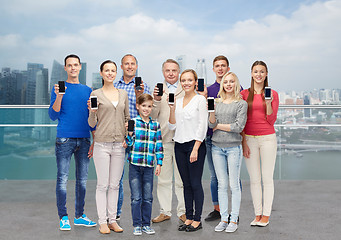 Image showing happy people with smartphones over city waterside