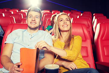 Image showing happy friends watching movie in theater