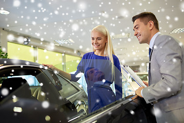 Image showing happy woman with car dealer in auto show or salon