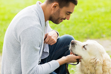 Image showing close up of man with labrador dog outdoors