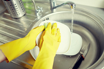 Image showing close up of woman hands washing dishes in kitchen