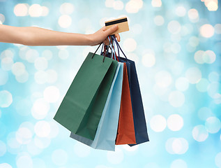 Image showing close up of woman with shopping bags and bank card