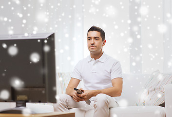 Image showing man with remote control watching tv