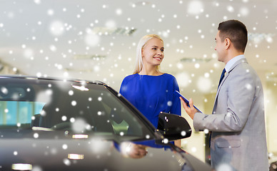 Image showing happy woman with car dealer in auto show or salon