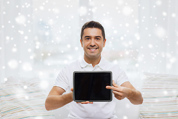 Image showing smiling man showing tablet pc blank screen at home