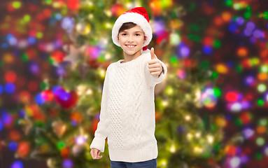 Image showing smiling happy boy in santa hat showing thumbs up