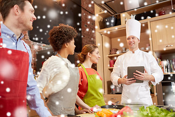 Image showing happy friends with tablet pc in kitchen