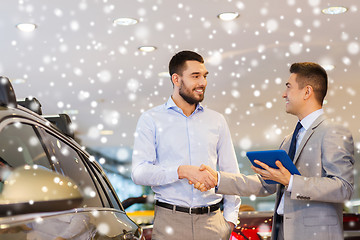 Image showing happy man shaking hands in auto show or salon