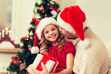 Image showing smiling father and daughter holding gift box