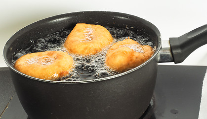 Image showing Donuts cooking in boiling oil in kettle