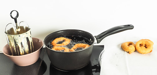 Image showing Donut maker in bowl, donuts boiling and donuts resting