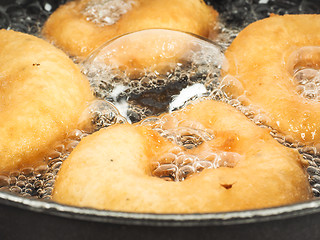 Image showing Closeup of donuts cooking in boiling oil in kettle