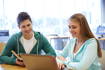 Image showing happy students with laptop and books at library