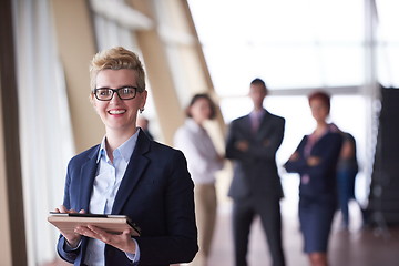 Image showing business woman  at office with tablet  in front  as team leader