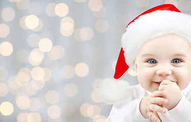 Image showing happy baby in santa hat over holidays lights