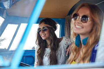 Image showing smiling young hippie women driving minivan car