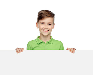 Image showing happy boy in t-shirt holding white blank board