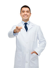 Image showing smiling male doctor in white coat pointing at you