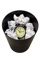 Image showing Clock in waste paper basket

