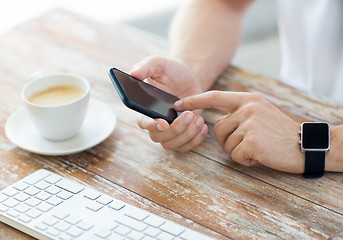 Image showing close up of hands with smart phone and watch